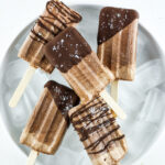 Chocolate drizzled fudgesicles made with cottage cheese.