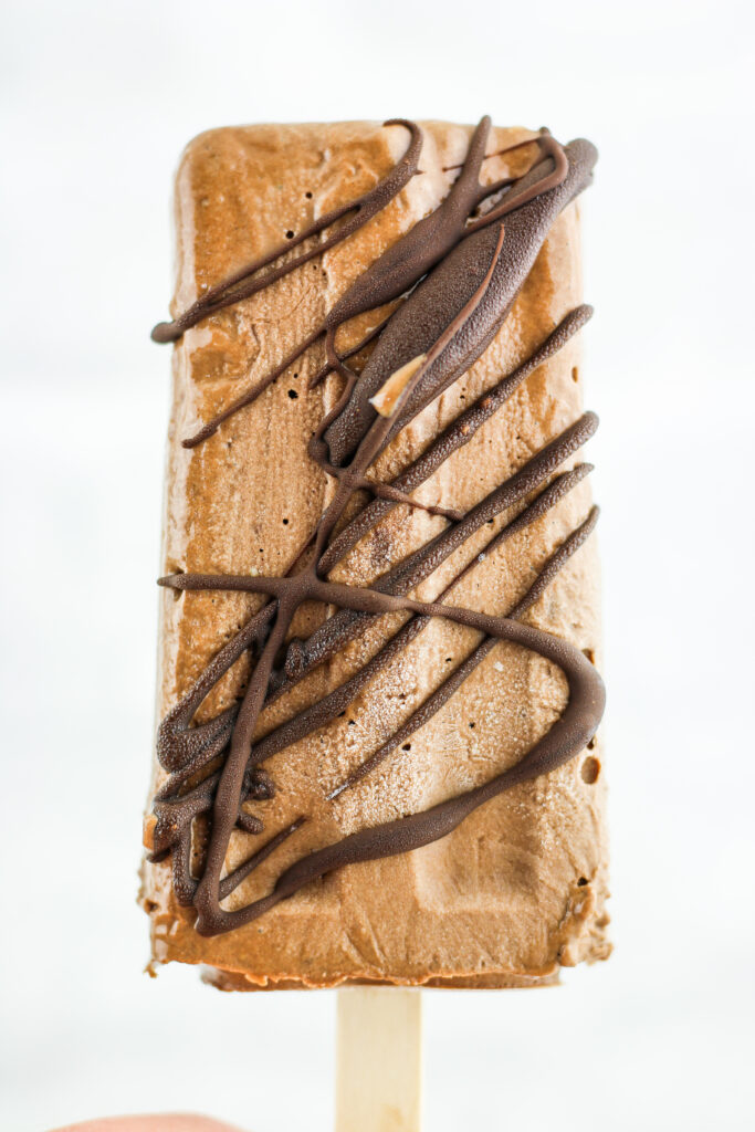 Chocolate drizzled fudgesicles made with cottage cheese.