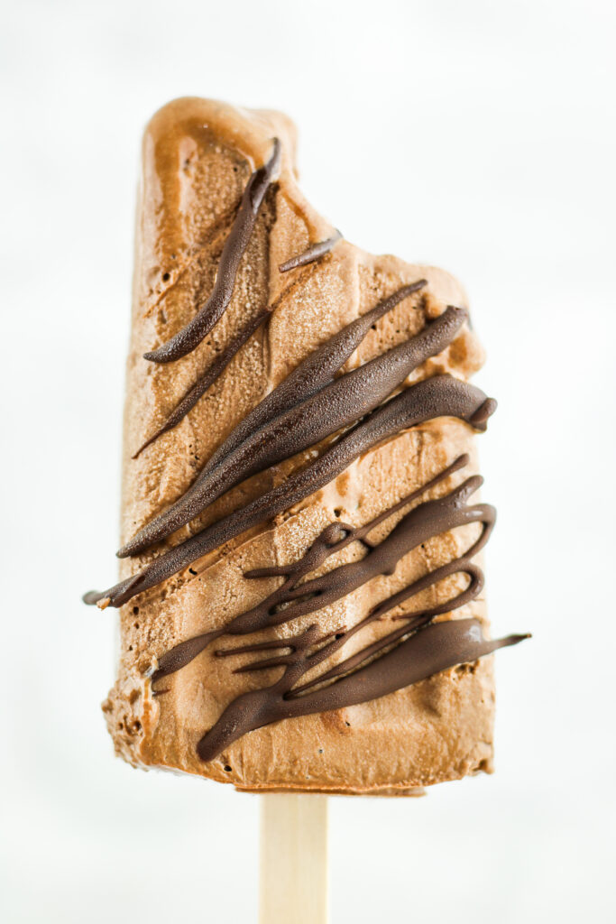 Chocolate drizzled fudgesicles made with cottage cheese.