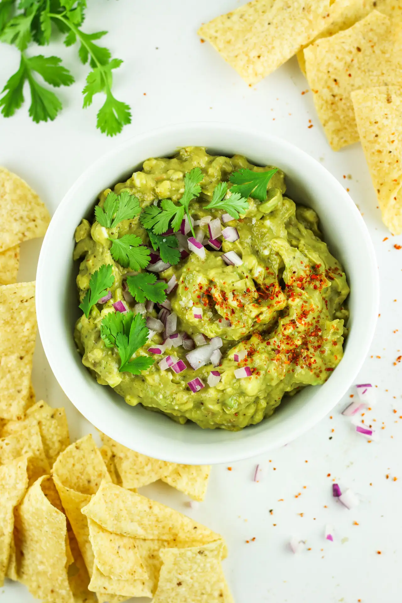 A bowl of cottage cheese guacamole with chips to enjoy this high protein dip.