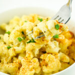 A warm bowl of Cottage Cheese Mac and Cheese topped with fresh chives.