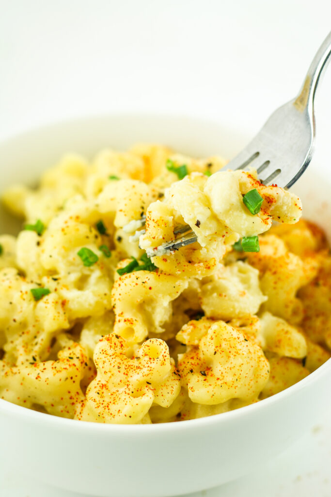 A warm bowl of Cottage Cheese Mac and Cheese topped with fresh chives.