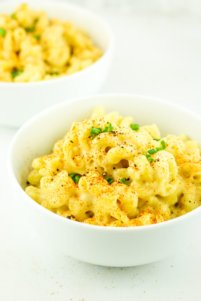 A warm bowl of Cottage Cheese Mac and Cheese topped with fresh chives.