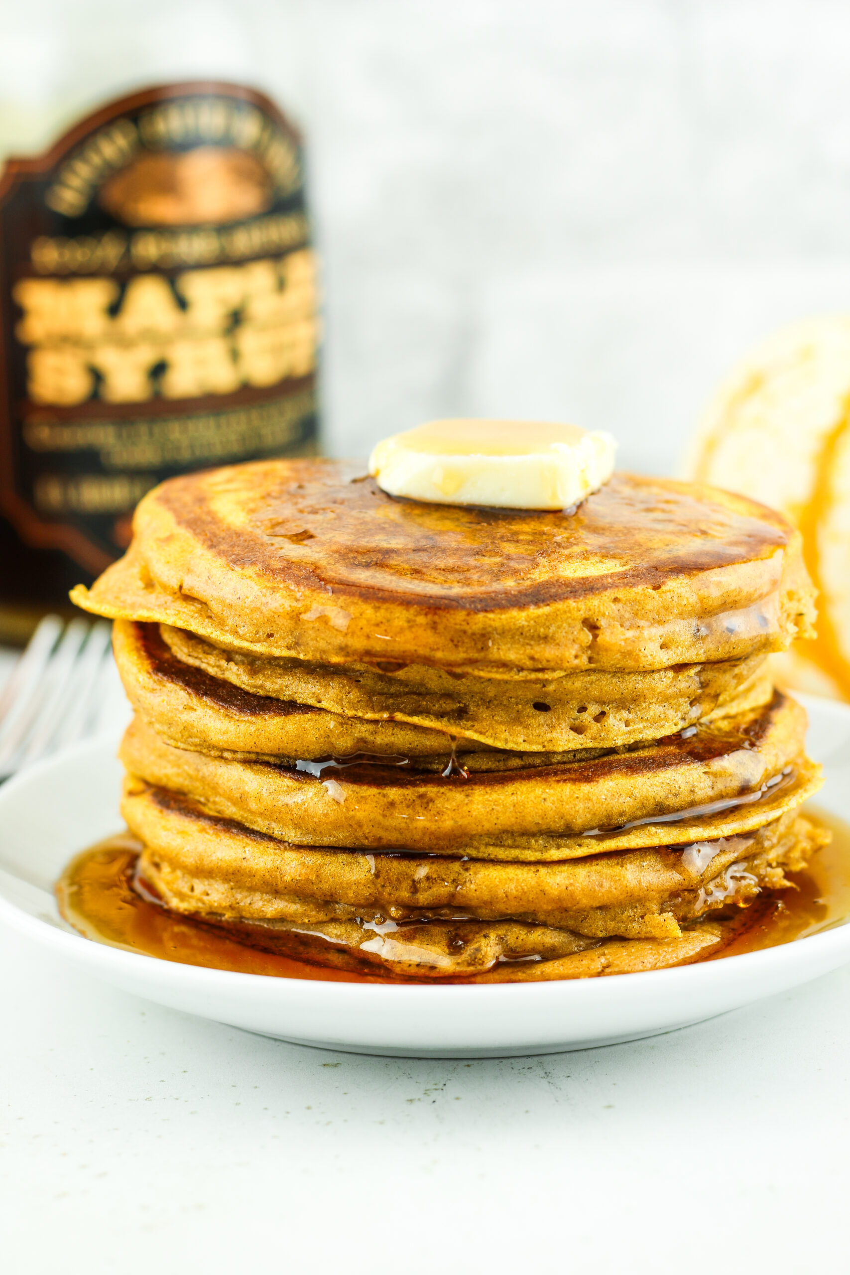 Stack of fluffy pumpkin cottage cheese pancakes.